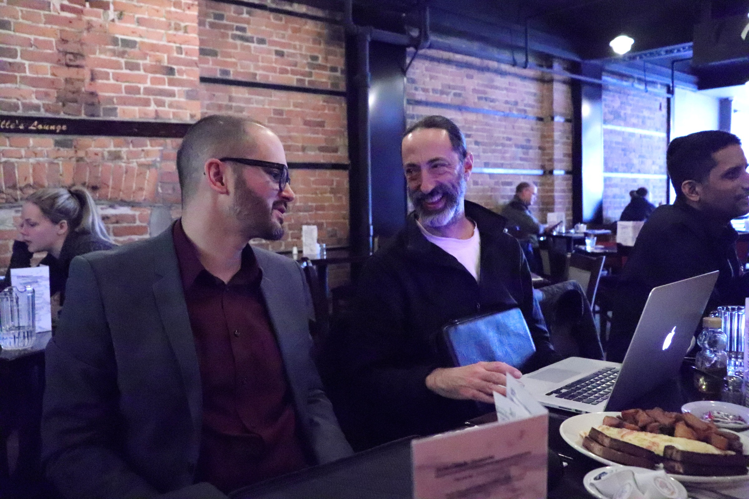SEO Brunch Jan 27 2020IMG_0678 Michael MacMillan and John Kopano seated in front of a laptop in a diner talking about SEO.